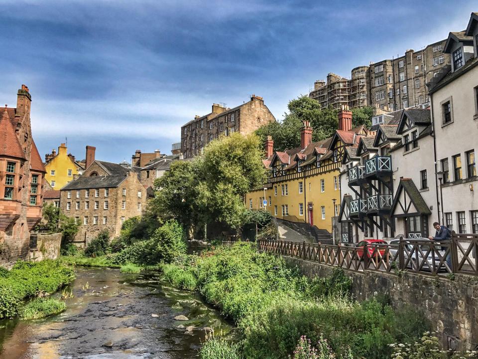 Old buildings reflected in a river.