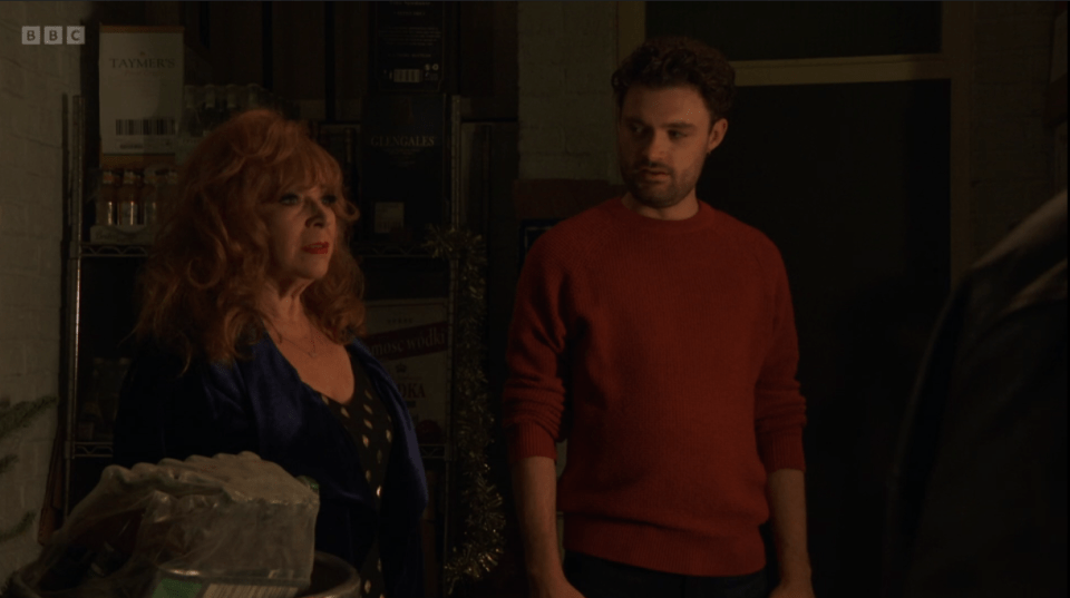 A scene from EastEnders; a woman and a man are talking.