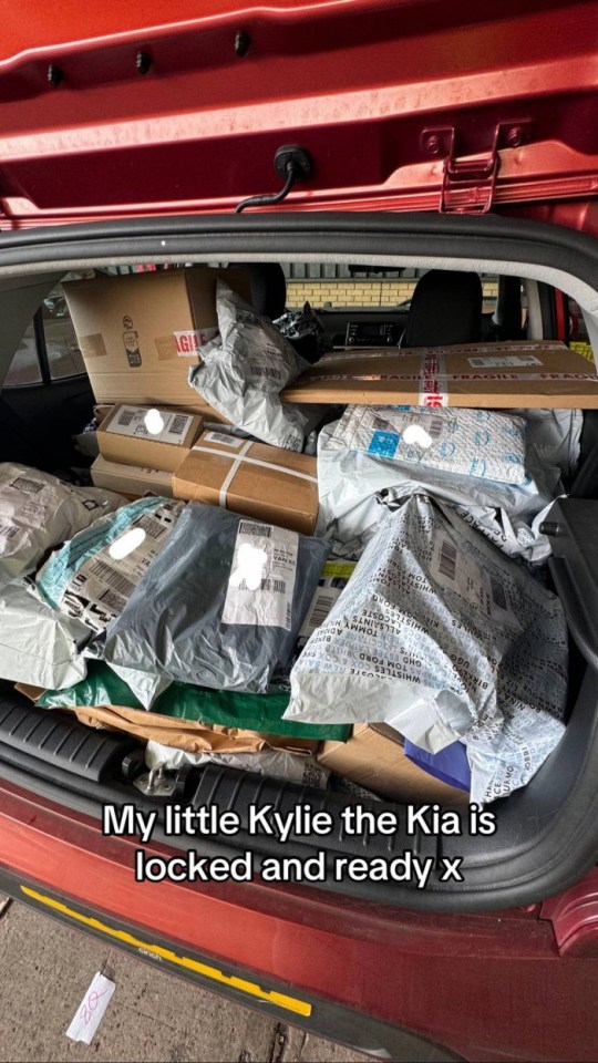 A Kia car's trunk full of packages ready for delivery.