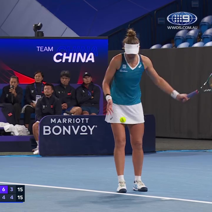 Tennis player serving underarm while in pain.