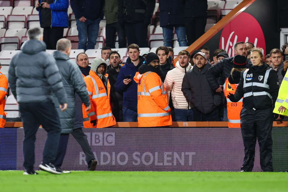 Tottenham Hotspur manager Ange Postecoglou confronts angry fans.