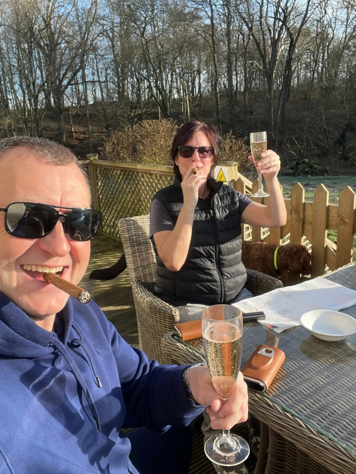 Couple enjoying champagne and cigars outdoors.