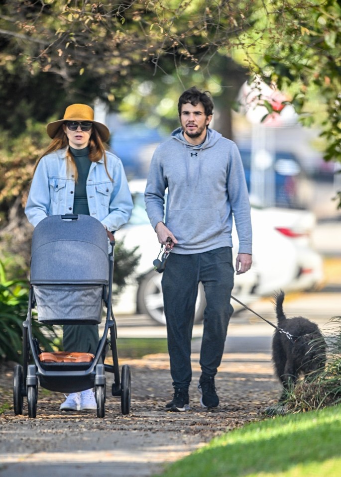 Karen Gillan and Nick Kocher stroll with their baby and dog.