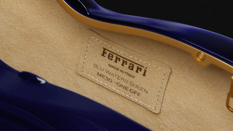 Close-up of a Ferrari label on a dark blue interior.