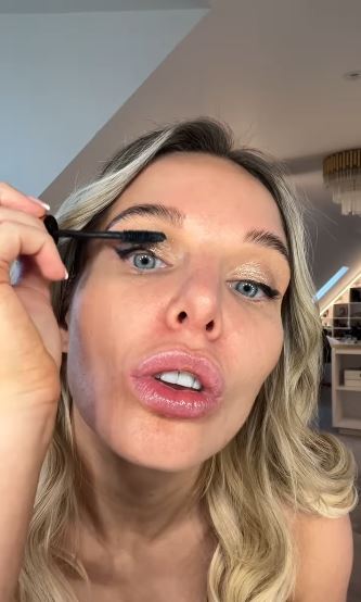 Woman applying mascara.