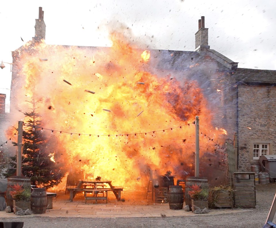 The Woolpack pub engulfed in flames.