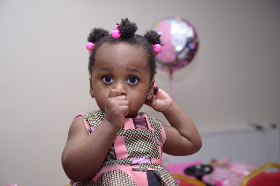 Toddler girl in pink dress.