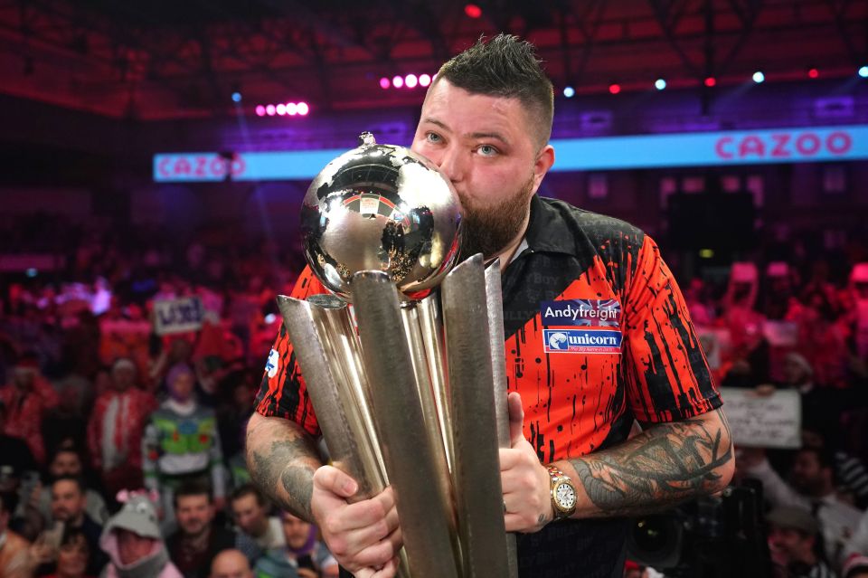 Michael Smith kisses the Sid Waddell trophy after winning the World Darts Championship.