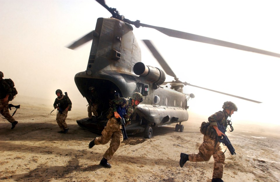British Royal Marines disembarking a Chinook helicopter during a vehicle checkpoint operation in southeastern Afghanistan.