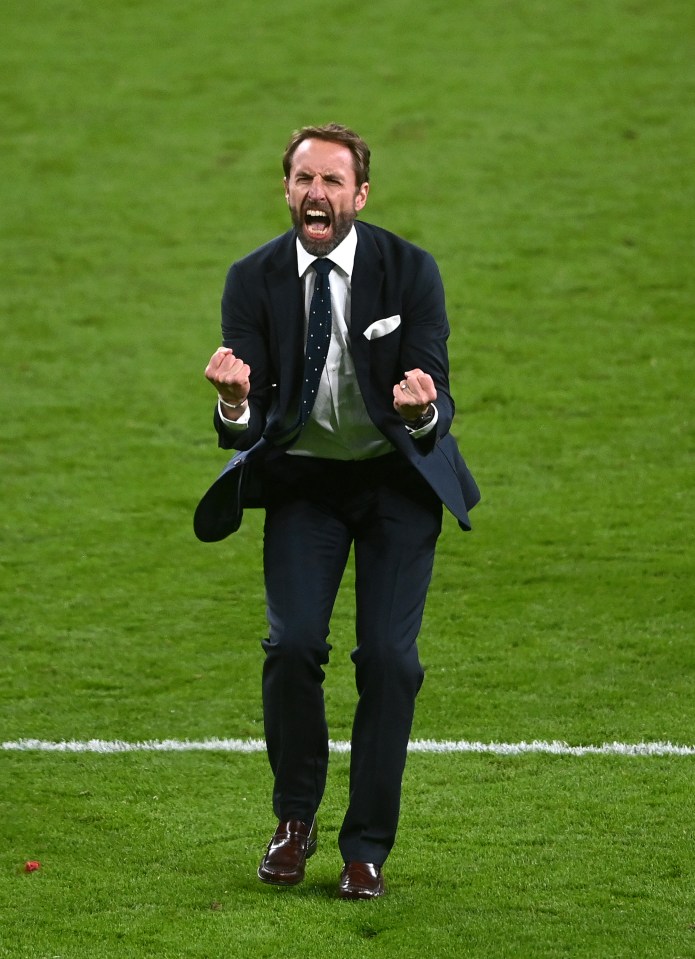 Gareth Southgate celebrating on the Wembley Stadium pitch after the Euro 2020 semi-final match.