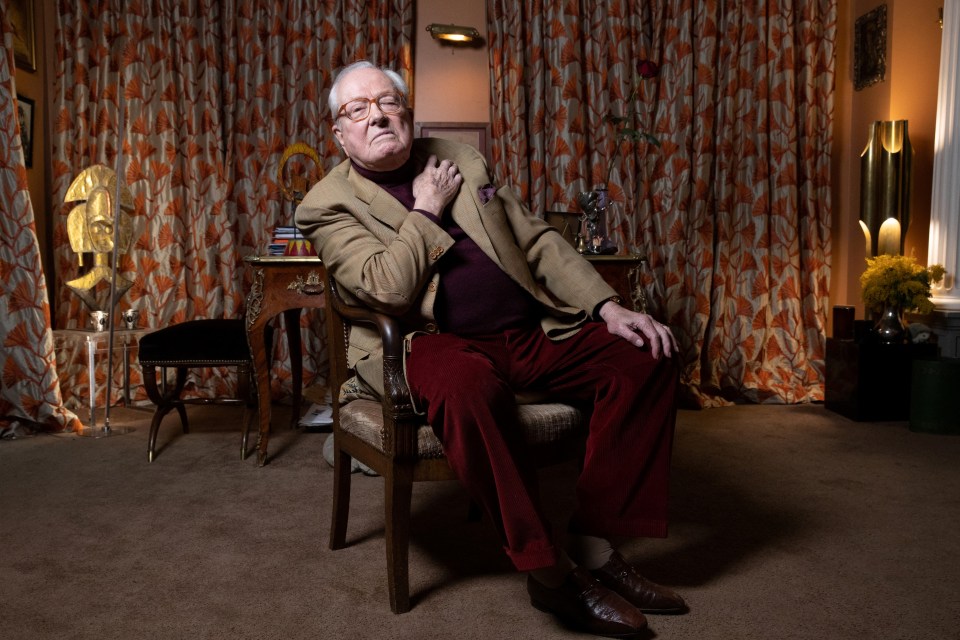 Jean-Marie Le Pen sitting in a chair at home.