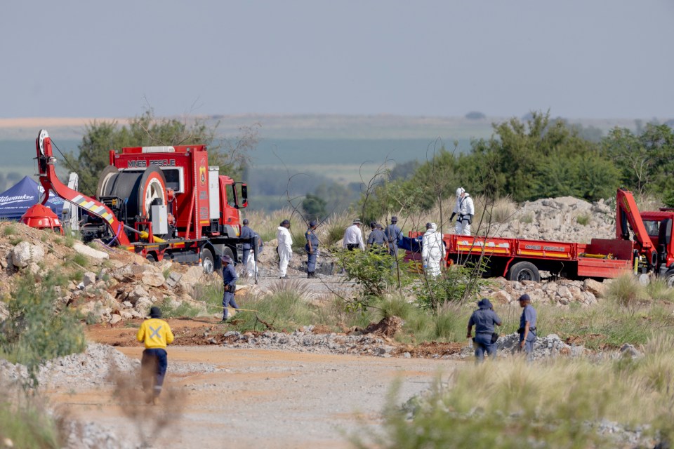 Rescue workers recovering bodies from an abandoned gold mine.
