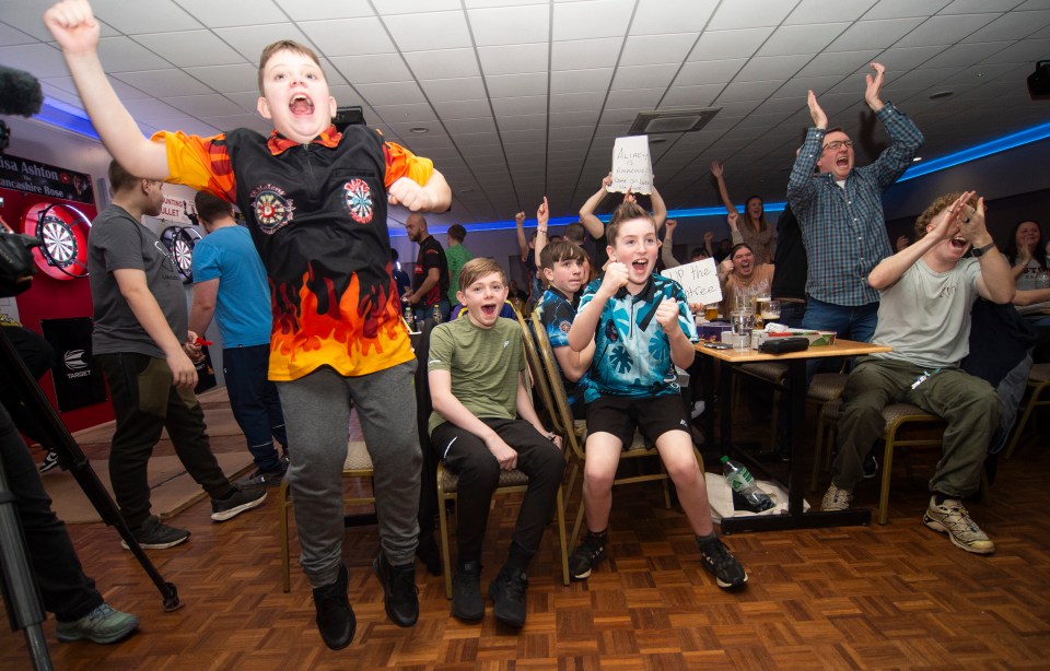 Excited fans at a darts competition.