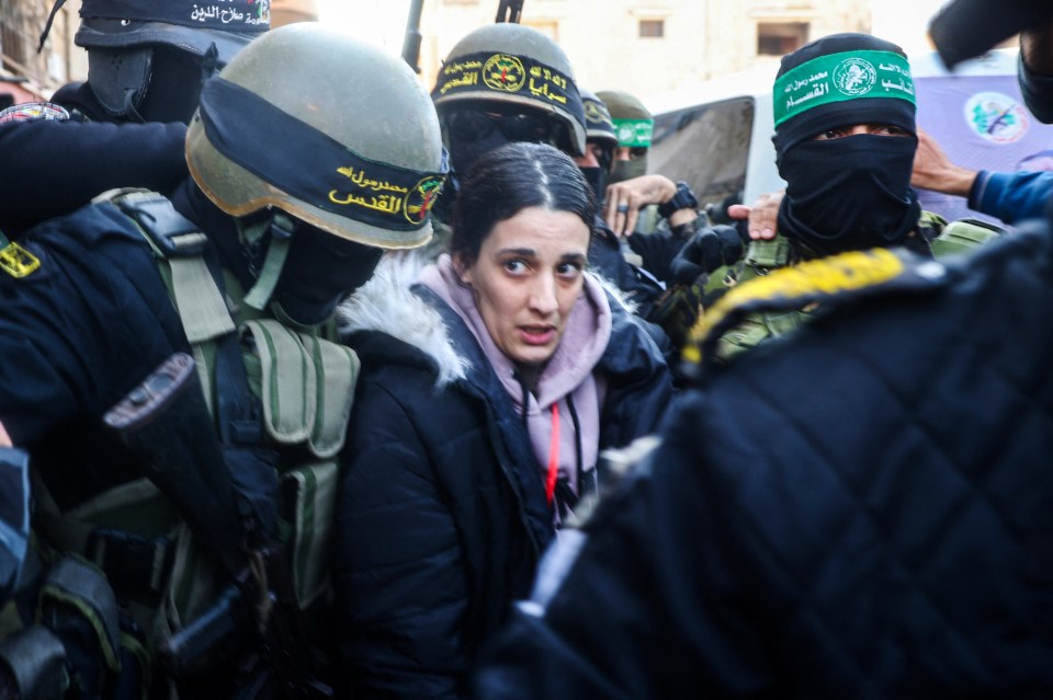 A woman escorted by armed militants.