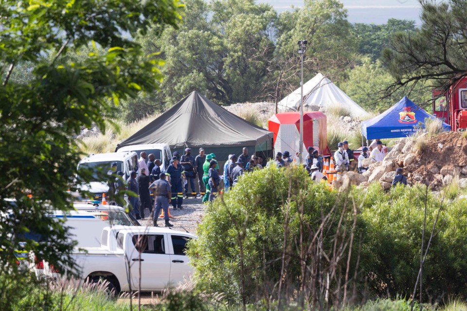 Rescue workers and police at a South African mine rescue operation.