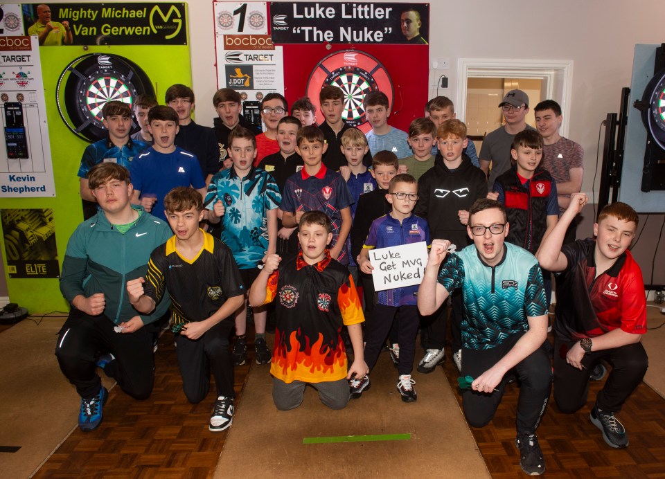 Young members of a darts academy wish Luke Littler luck before a PDC final.