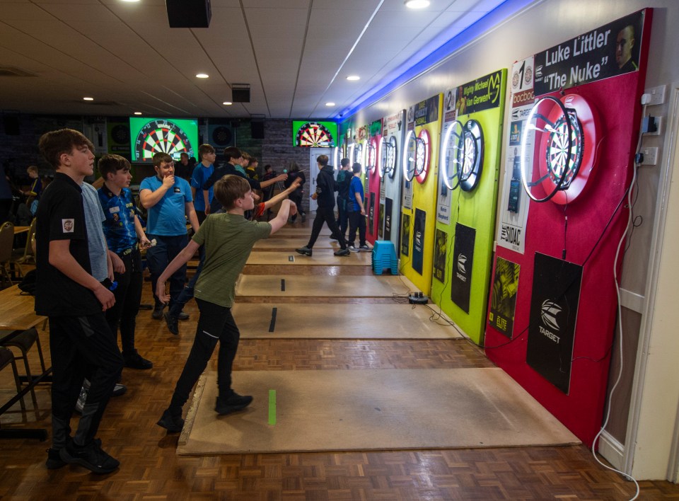 Young dart players at a St. Helens academy practice.