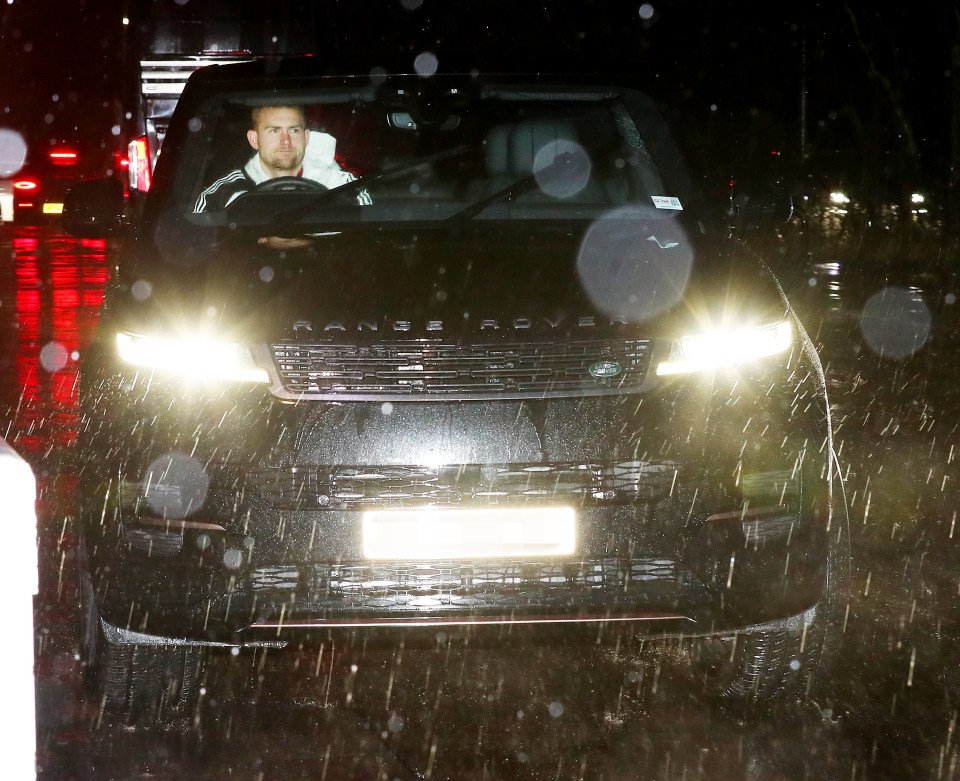 Matthijs de Ligt driving a car in the rain.