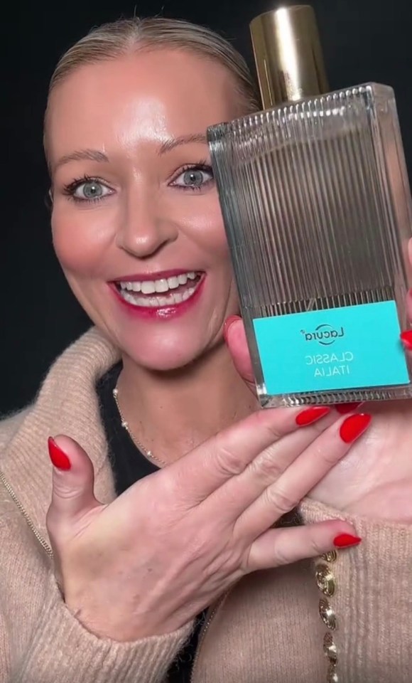 Woman holding up a bottle of Aldi's £6.99 perfume dupe of Victoria Beckham's £170 perfume.