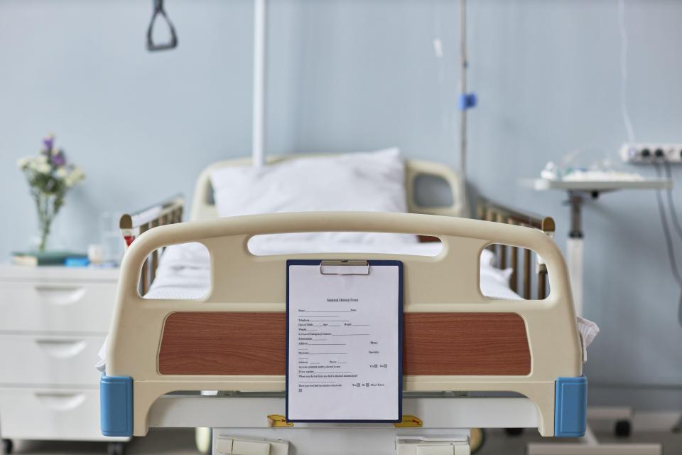 Medical history form on a hospital bed.
