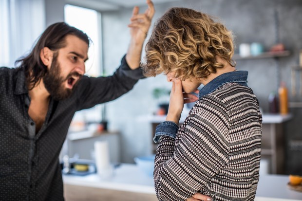 A man shouting at a distressed woman.