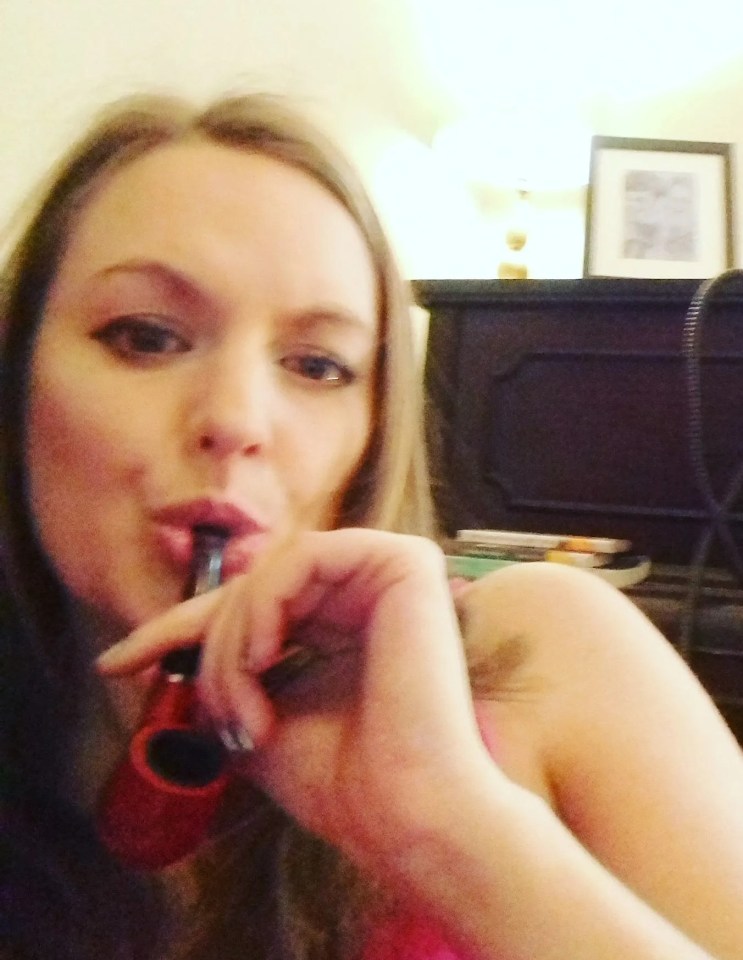 Woman smoking a pipe.