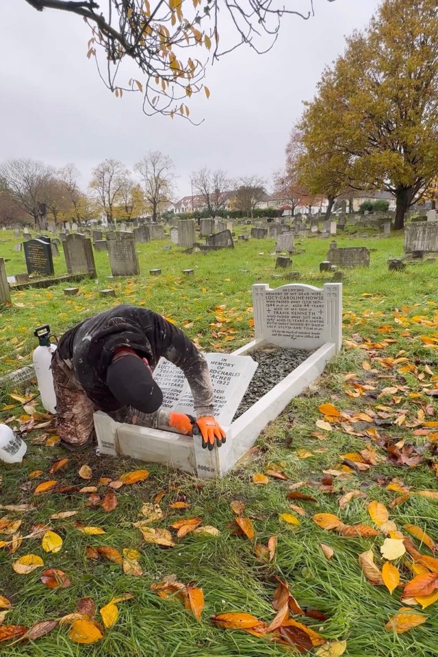 A man cleaning a gravestone in a cemetery.