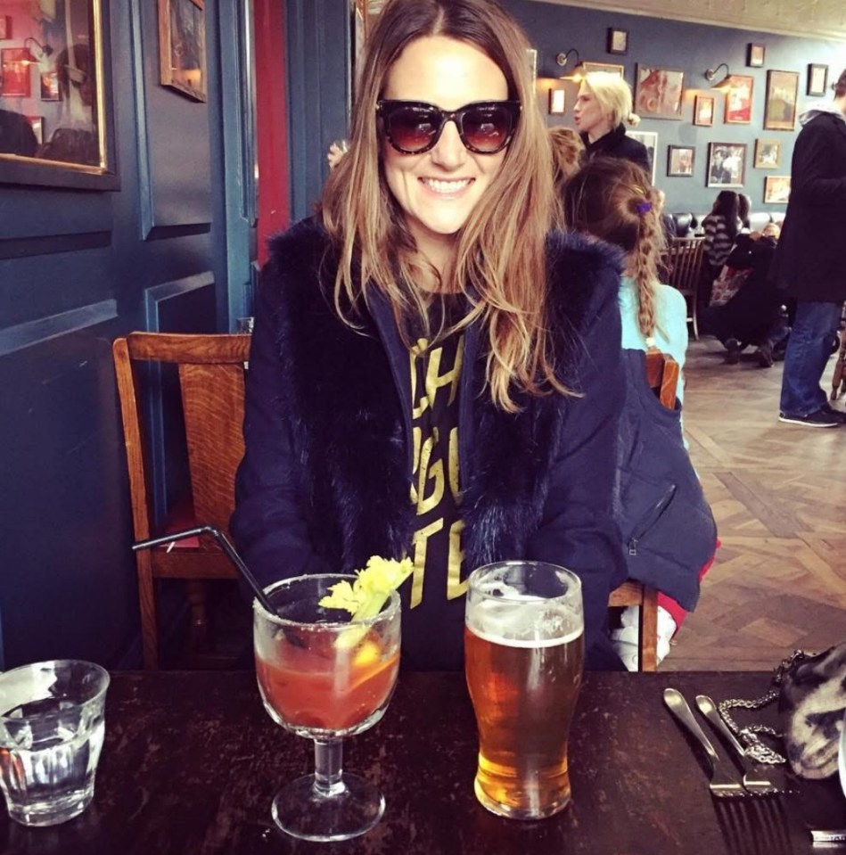 Woman sitting at a table with a Bloody Mary and beer.