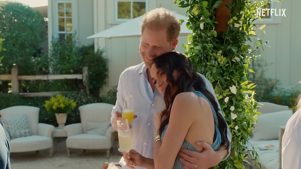 Prince Harry and Meghan Markle embracing outdoors.
