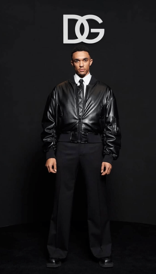 Man in black leather jacket and trousers at Dolce & Gabbana event.