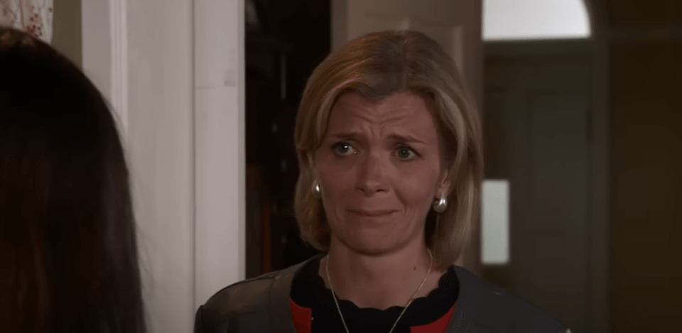 A woman with blonde hair looking upset.