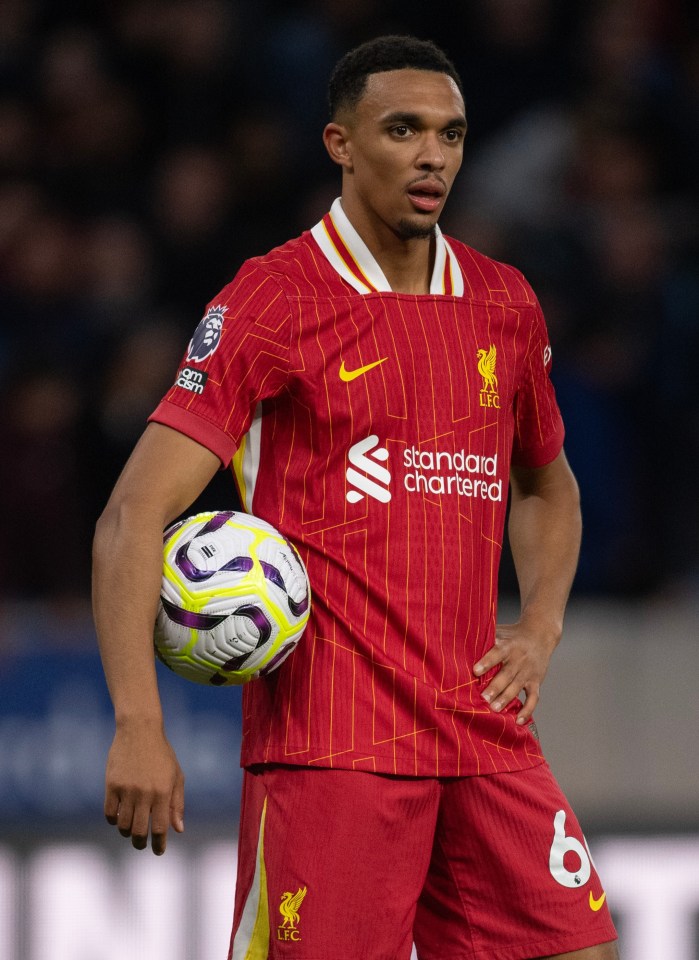 Liverpool soccer player holding a ball.