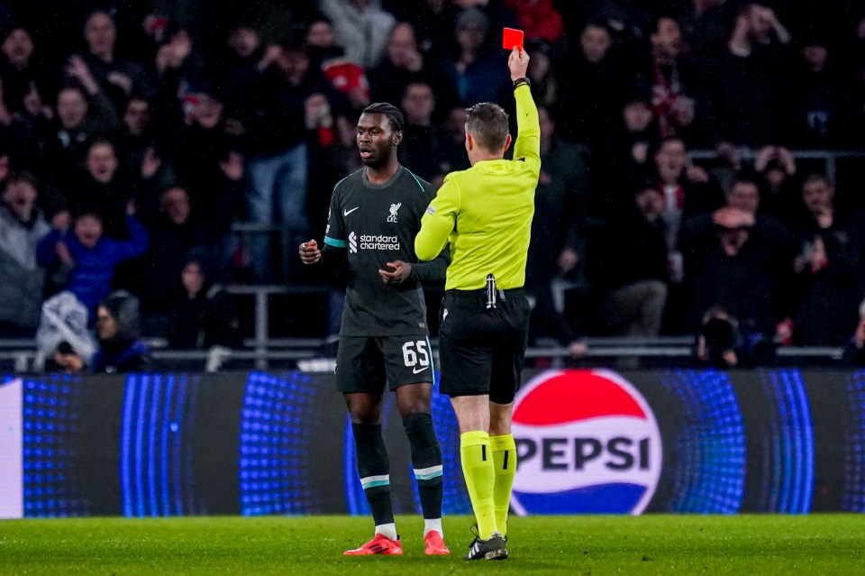 Amara Nallo of Liverpool receiving a red card from a referee.