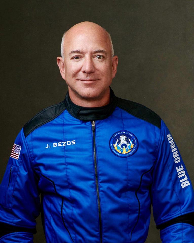 Jeff Bezos in a blue Blue Origin flight suit.
