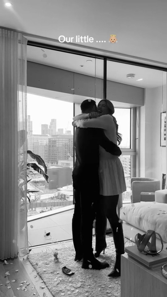 Couple embracing at gender reveal.