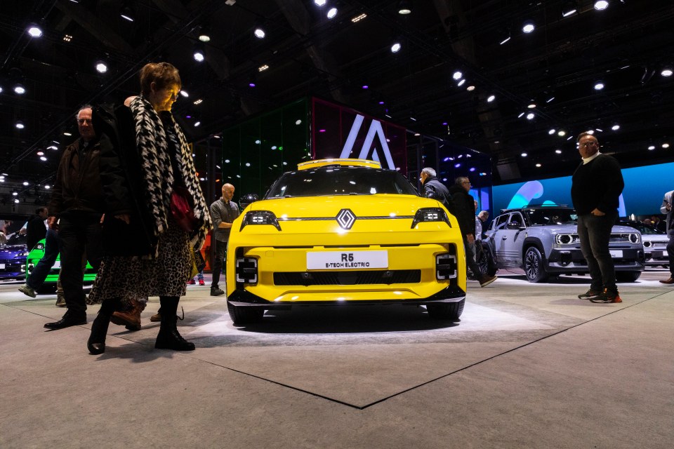Yellow Renault 5 E-Tech electric car at a car show.