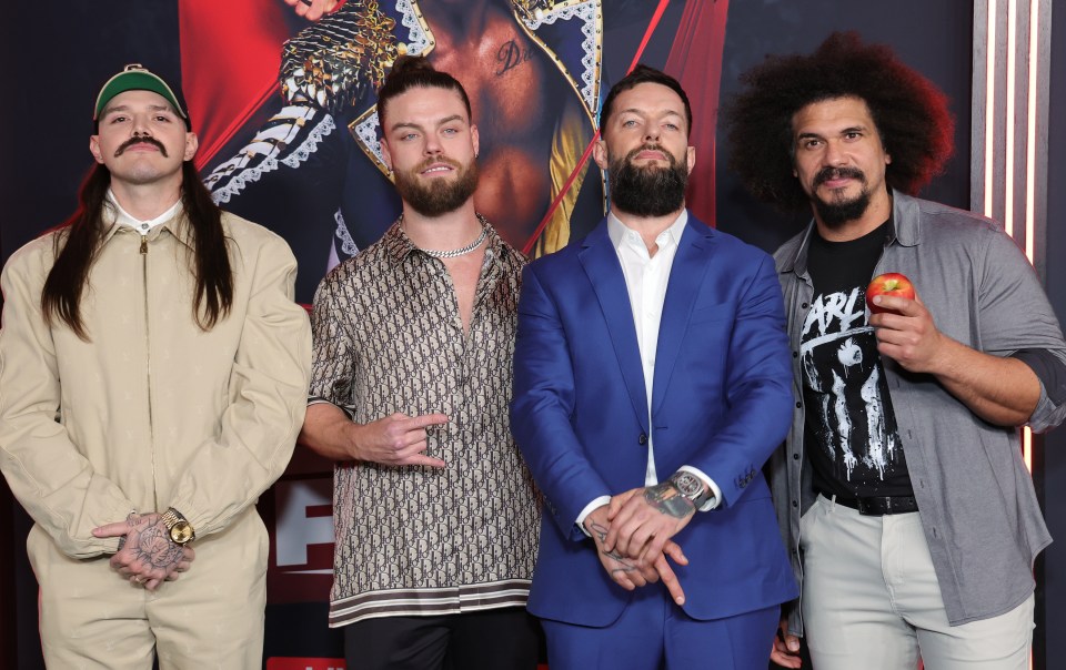 Dominik Mysterio, JD McDonagh, Finn Balor, and Carlito at a WWE event.