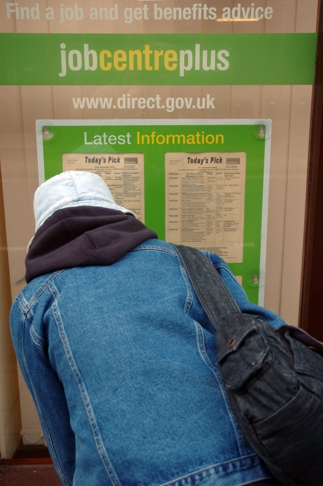 Woman looking at job vacancies at a Job Centre Plus.