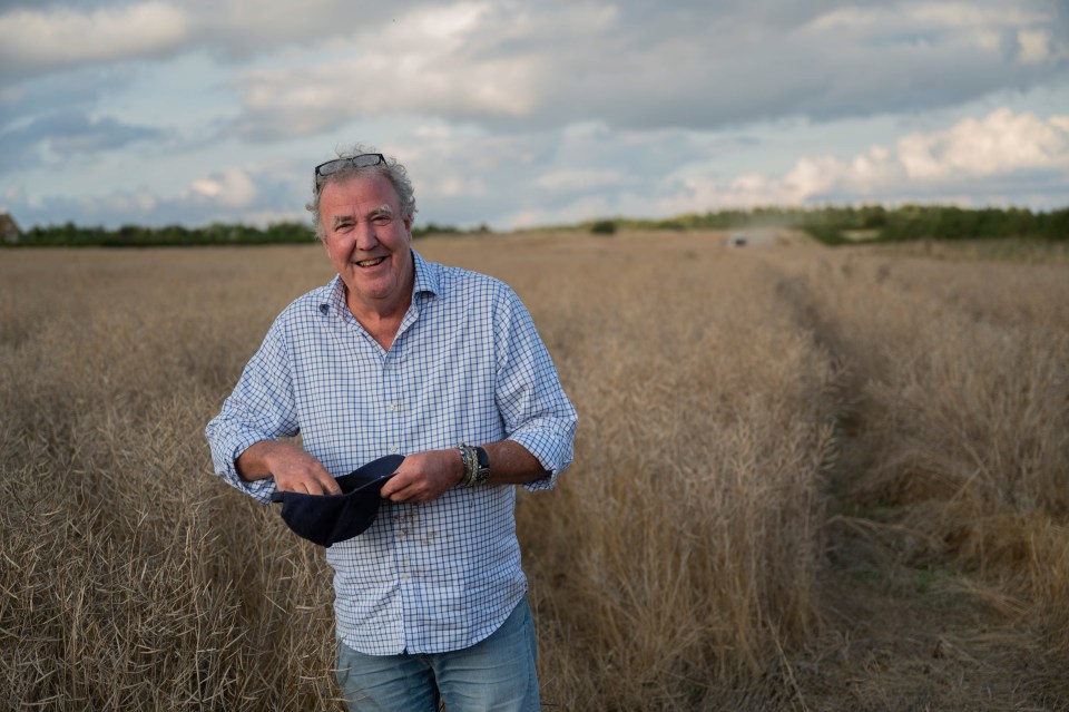 Jeremy Clarkson in a field, holding a cap.