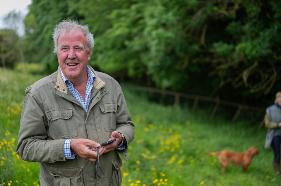 Jeremy Clarkson on his farm, looking at his phone.