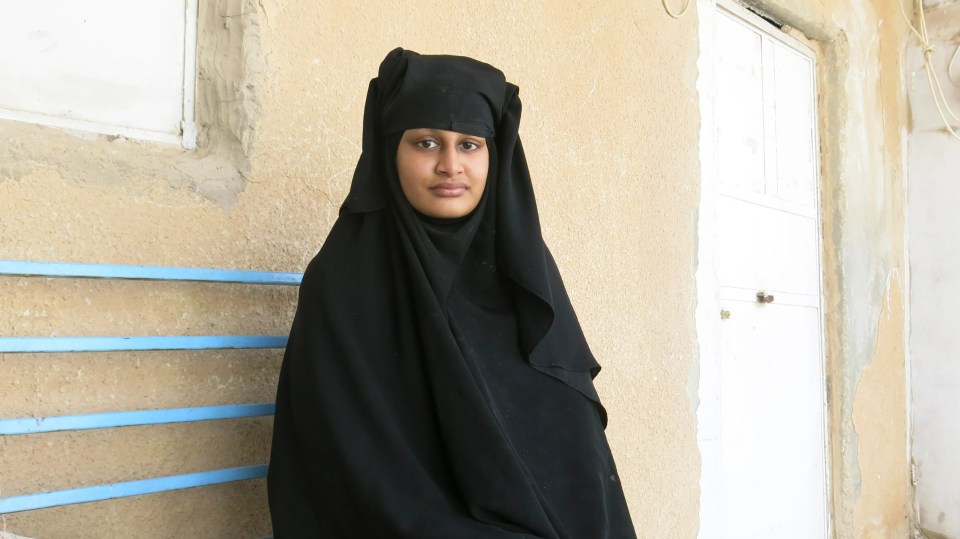 Shamima Begum, a young woman in a niqab, sits on a bench.