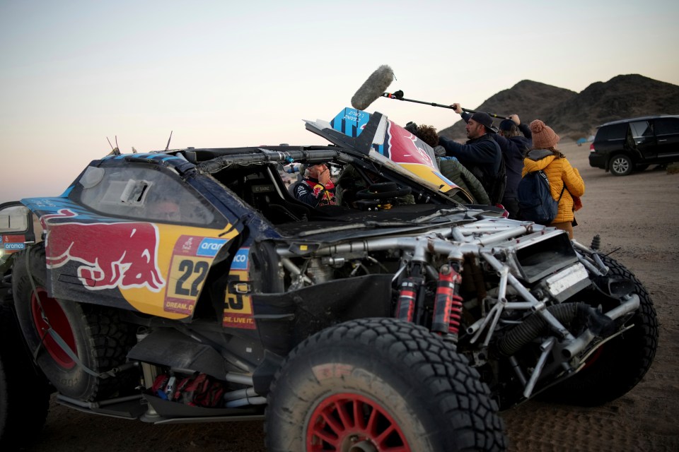 Carlos Sainz speaks to journalists after a Dakar Rally crash.