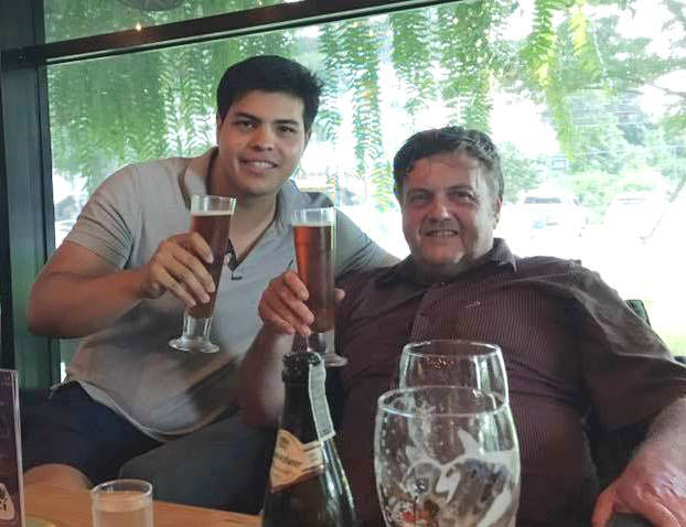 English teacher David Armitage with his son in a cafe.