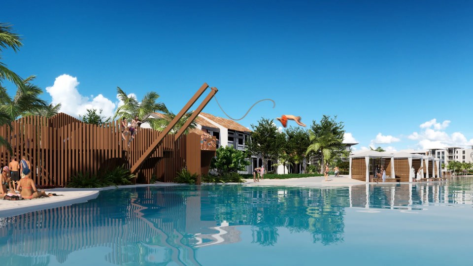 People enjoying a resort pool and rope swing.