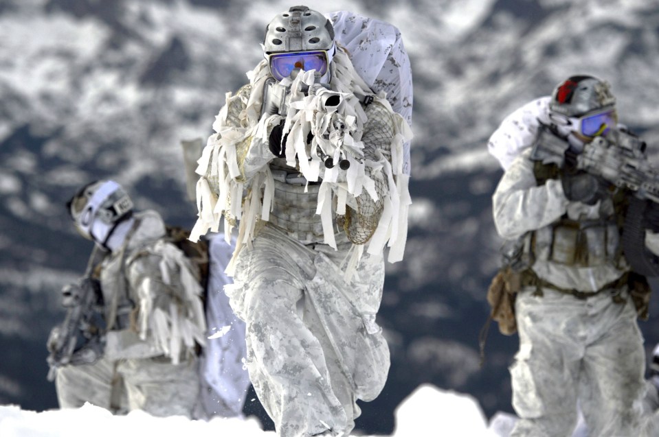 Finnish special forces soldiers in winter camouflage during a military exercise.