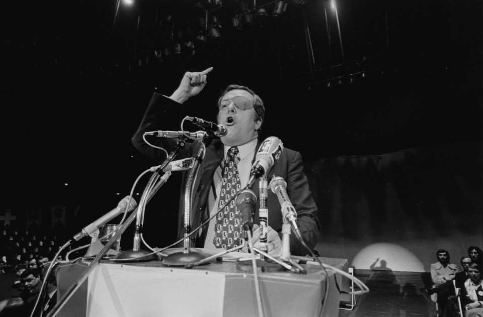 Jean-Marie Le Pen giving a speech at a political rally.