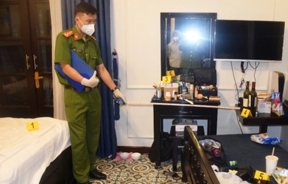Crime scene investigators in a hotel room.