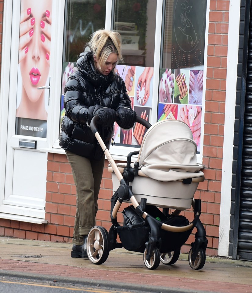 Jorgie Porter pushing a baby stroller.