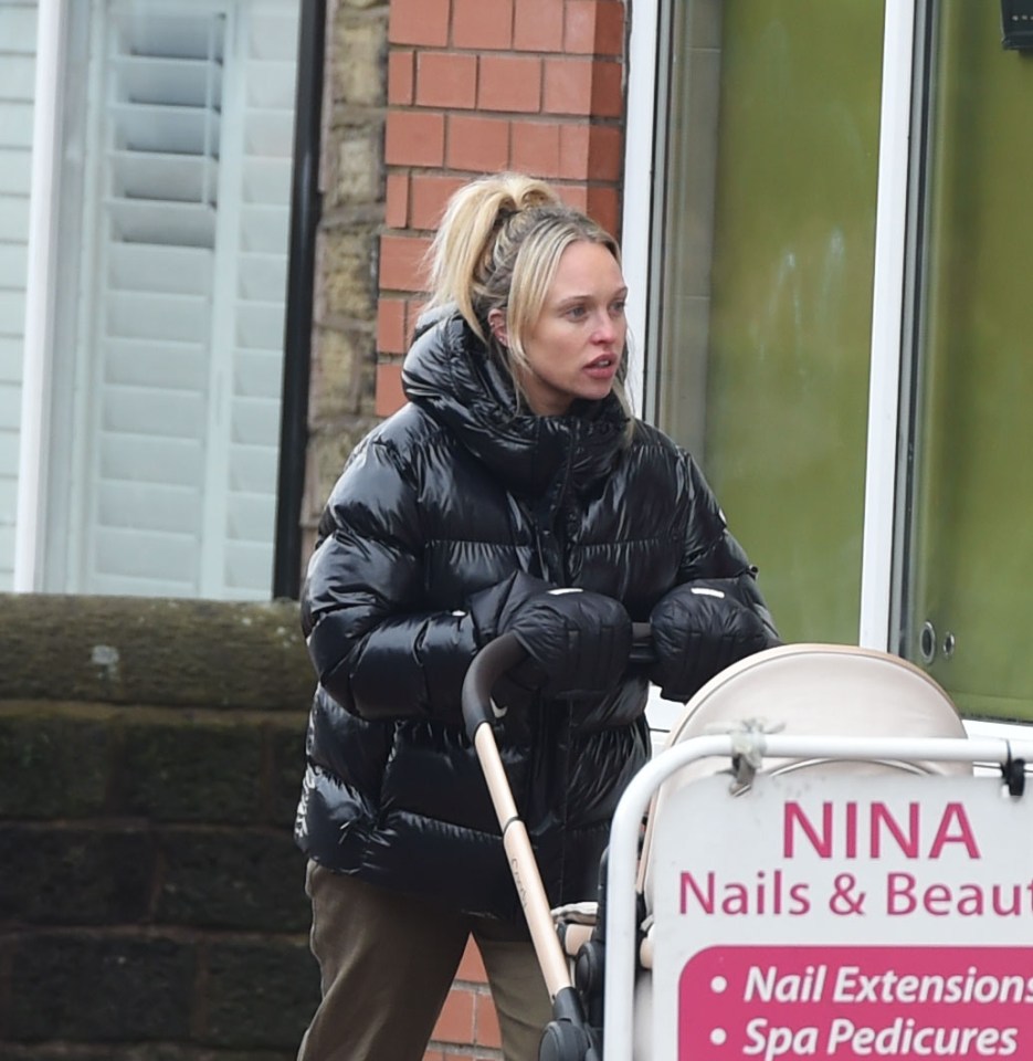Jorgie Porter pushing a pram.
