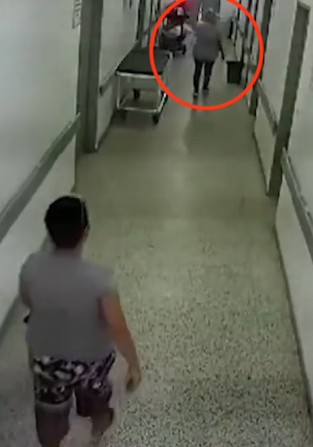 CCTV footage of a woman leaving a hospital with a baby.